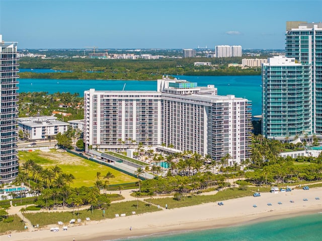 bird's eye view with a water view and a beach view