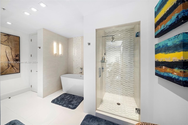 bathroom featuring tile patterned floors and separate shower and tub