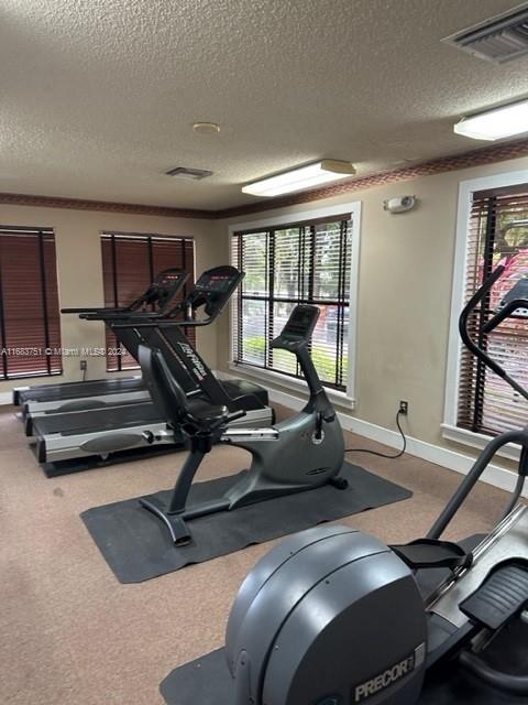 gym featuring a textured ceiling