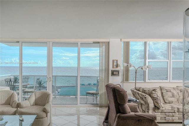 tiled living room featuring a water view and plenty of natural light