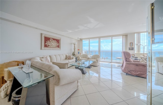 tiled living room featuring expansive windows and a water view