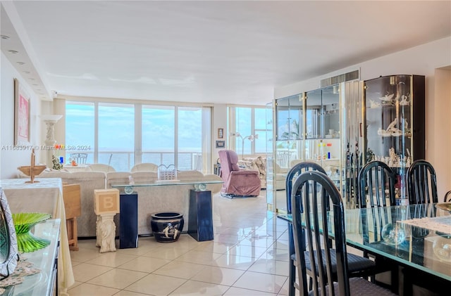 tiled dining room featuring a water view