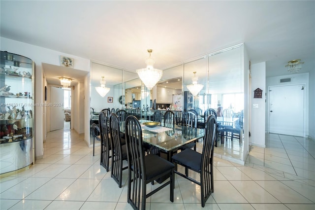 dining area featuring a healthy amount of sunlight, light tile patterned flooring, and a chandelier