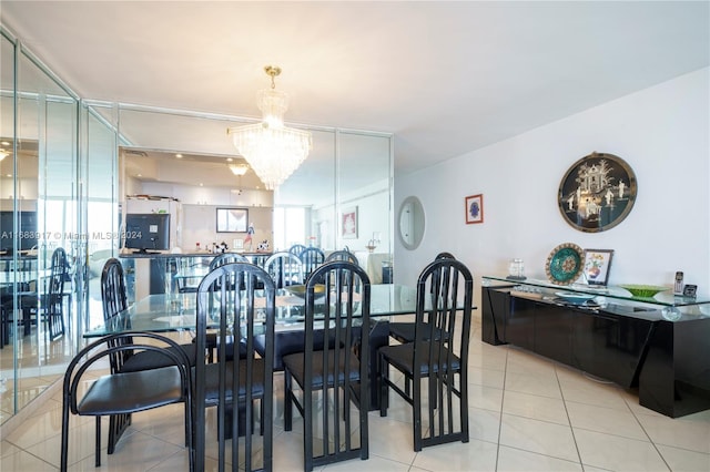 dining area with a chandelier and light tile patterned flooring