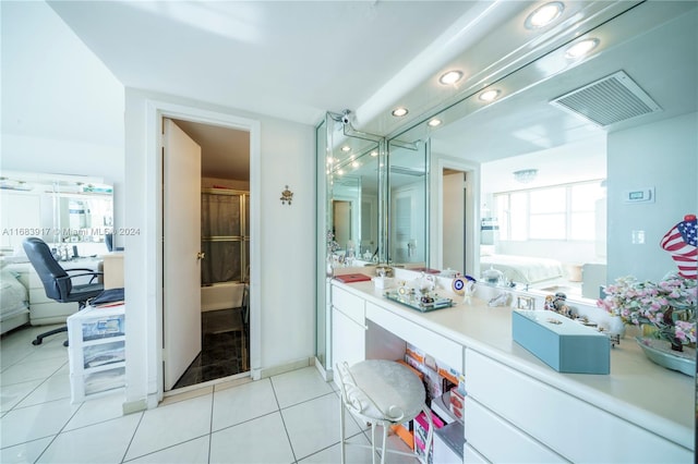 bathroom featuring vanity, tile patterned floors, and a shower with door