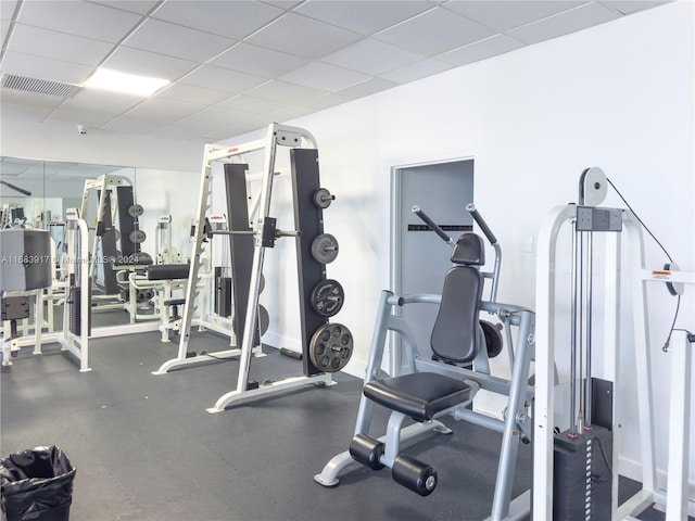 exercise room with a paneled ceiling