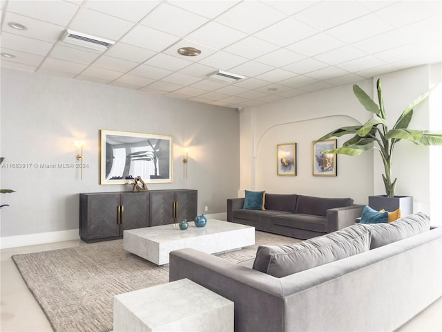 tiled living room with a paneled ceiling