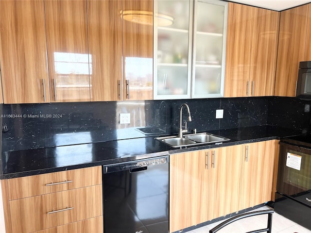 kitchen with tasteful backsplash, black appliances, sink, dark stone countertops, and light tile patterned floors