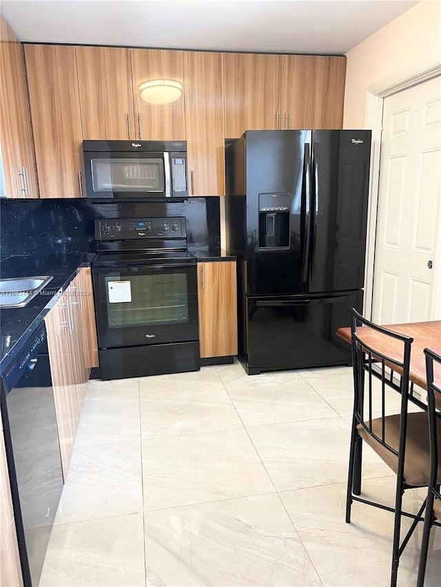 kitchen with tasteful backsplash and black appliances