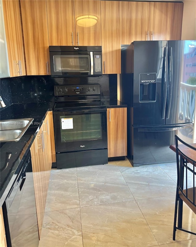 kitchen with black appliances, sink, and backsplash