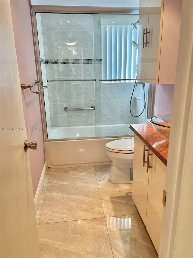 full bathroom with vanity, toilet, and bath / shower combo with glass door