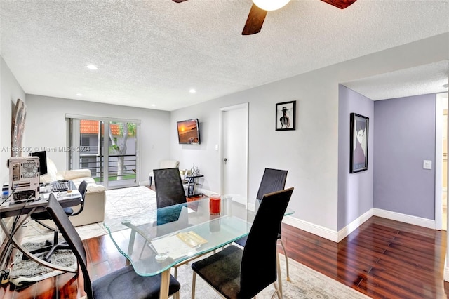 dining area with ceiling fan, wood-type flooring, and a textured ceiling