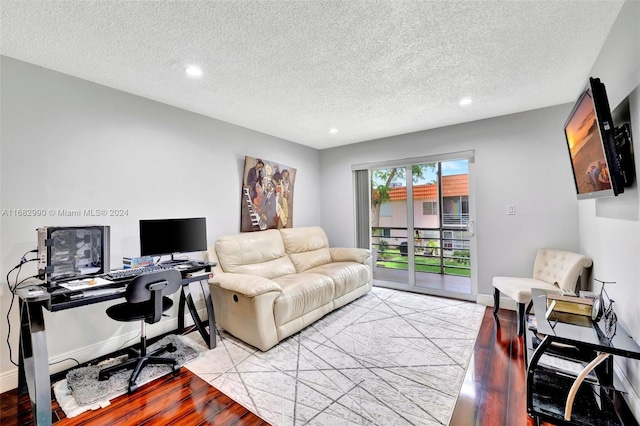 home office with a textured ceiling and light wood-type flooring