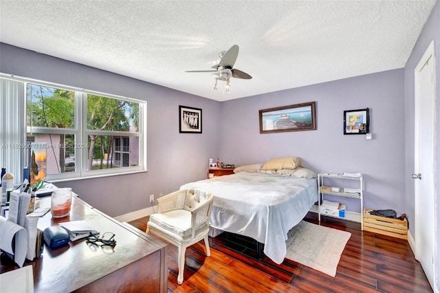 bedroom featuring a textured ceiling, dark wood-type flooring, and ceiling fan