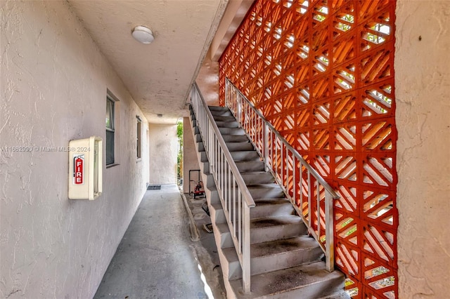 stairway featuring concrete flooring