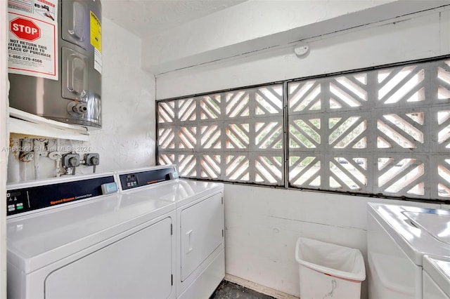 laundry room featuring washer and clothes dryer and water heater