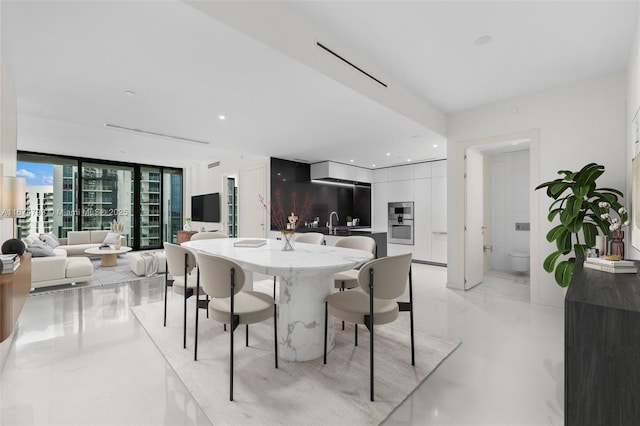 dining space with expansive windows, visible vents, and recessed lighting