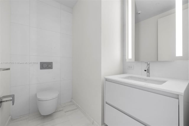 bathroom featuring tile walls, vanity, and toilet