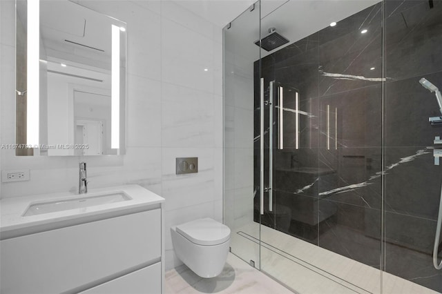 bathroom featuring toilet, a marble finish shower, vanity, and tile walls