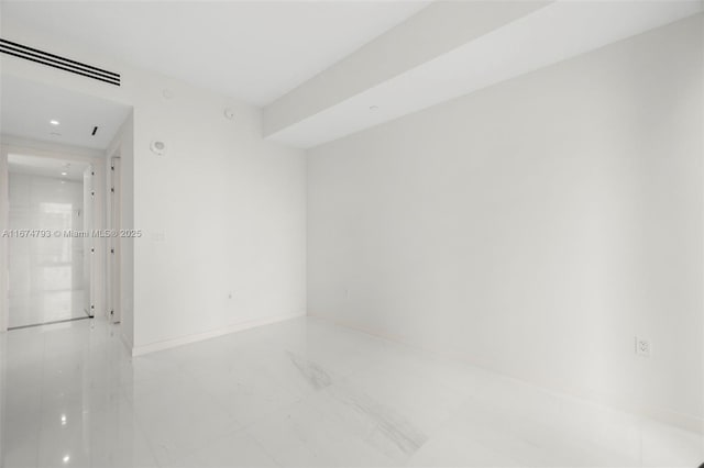 empty room featuring visible vents and baseboards