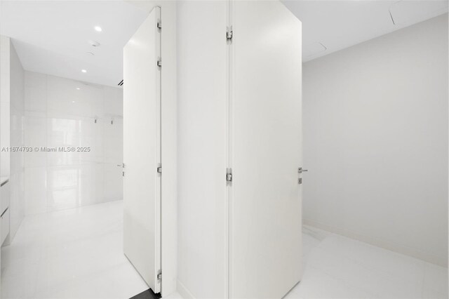 bathroom featuring tile walls, vanity, and toilet