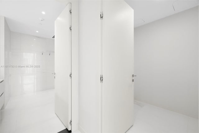 interior space with vanity, walk in shower, and recessed lighting