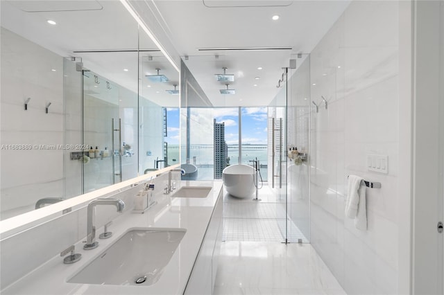 bathroom featuring vanity, expansive windows, and plus walk in shower