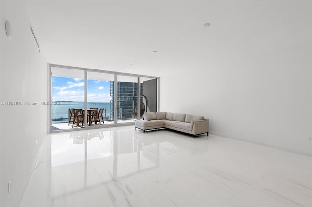 living room with a wall of windows and a water view