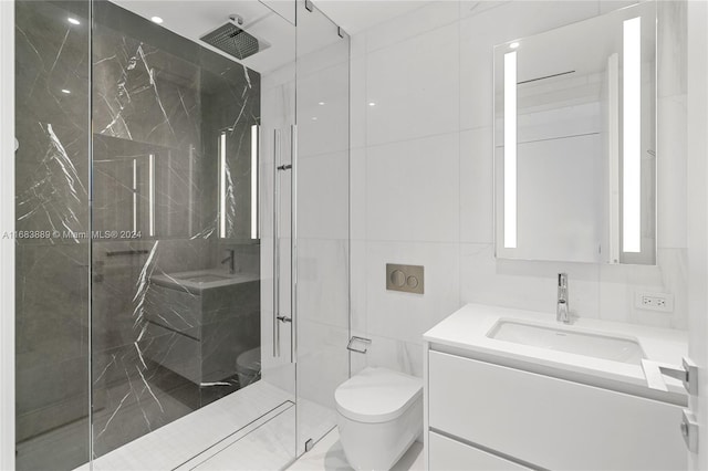 bathroom featuring vanity, toilet, tile walls, and a shower with door