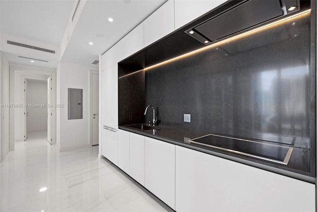 kitchen featuring dark countertops, white cabinetry, a sink, modern cabinets, and electric panel