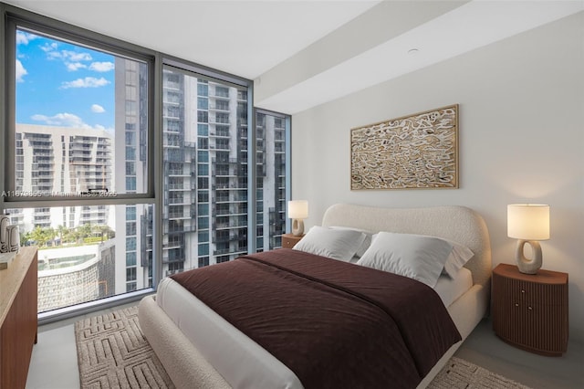 bedroom featuring floor to ceiling windows and a city view