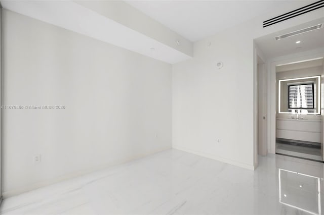 empty room featuring visible vents and baseboards