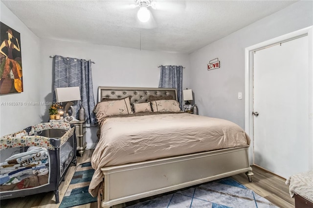 bedroom featuring a textured ceiling and hardwood / wood-style floors