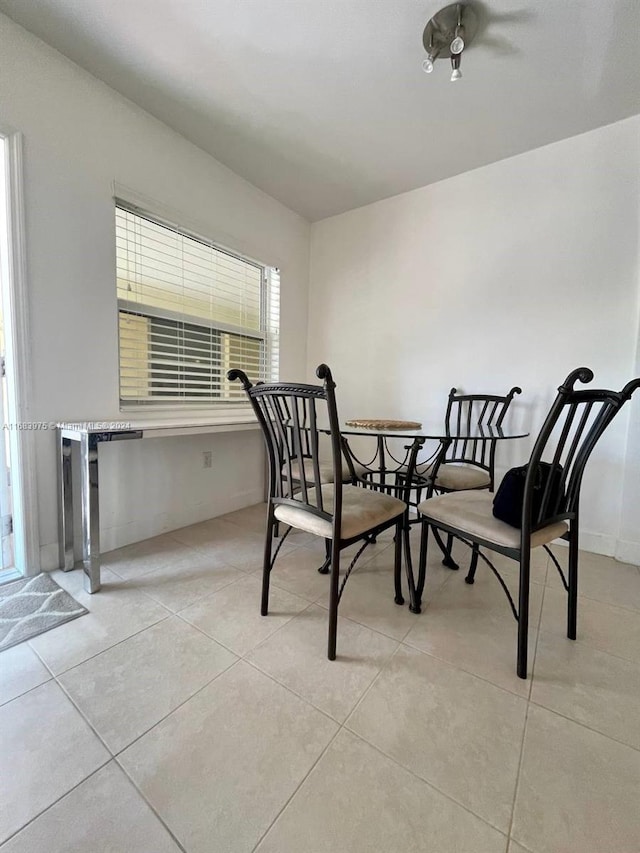 dining space featuring light tile patterned floors