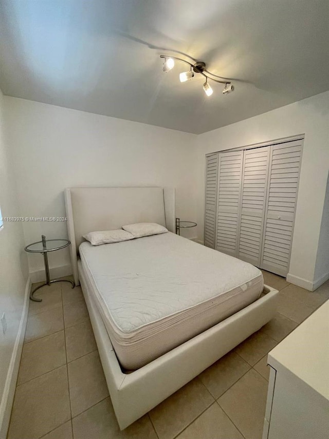 bedroom featuring a closet and light tile patterned floors