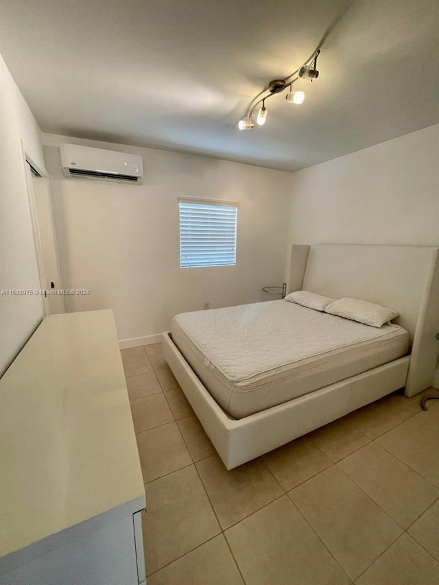 tiled bedroom featuring a wall mounted AC and track lighting