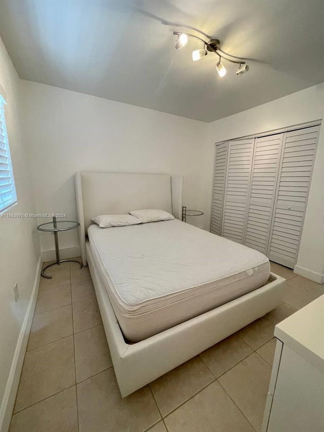 tiled bedroom featuring a closet