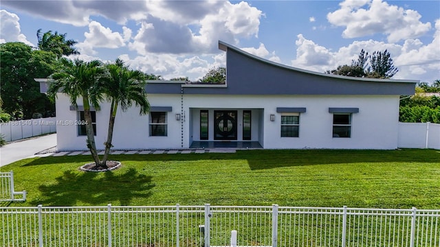 view of front of house with a front yard and a patio