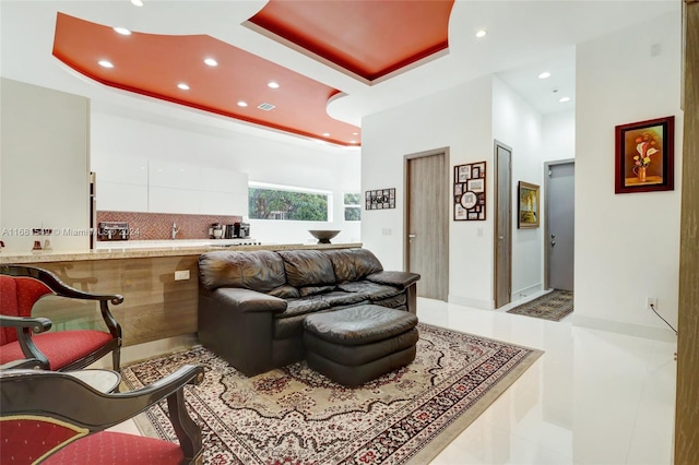 tiled living room with a tray ceiling