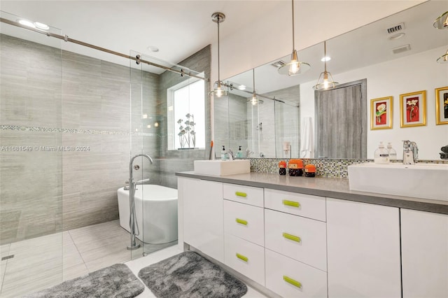 bathroom featuring vanity, decorative backsplash, shower with separate bathtub, and tile patterned flooring