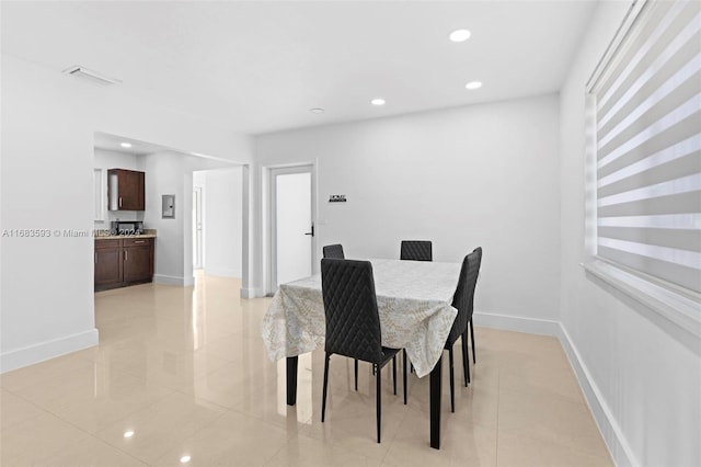 dining space featuring light tile patterned flooring