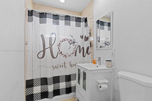 bathroom featuring vanity, toilet, and walk in shower