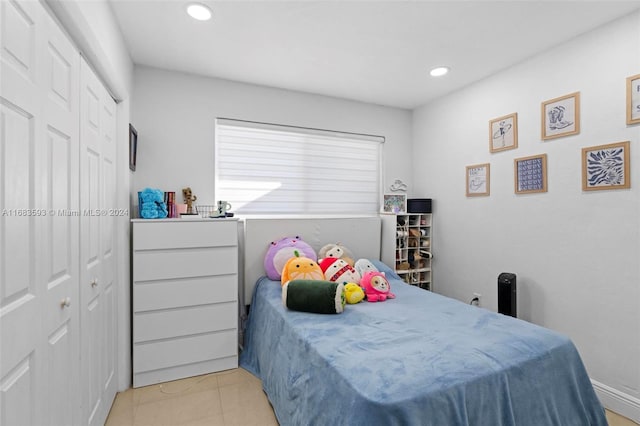 bedroom with a closet and light tile patterned floors