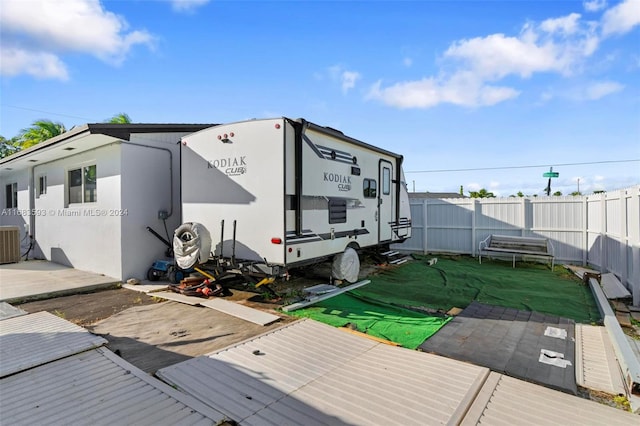 exterior space with a yard, a patio area, and central AC unit