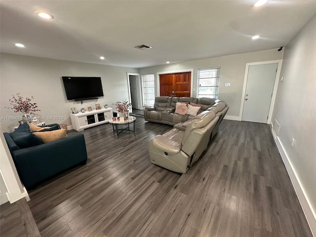 living room with dark hardwood / wood-style flooring