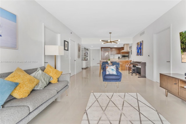 living room featuring a notable chandelier and light tile patterned floors