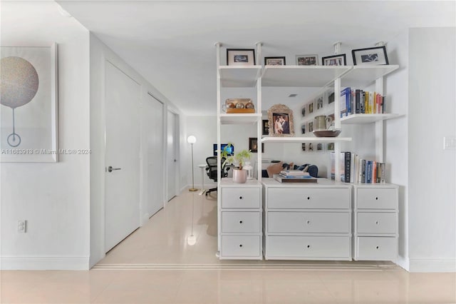 hall featuring light tile patterned floors