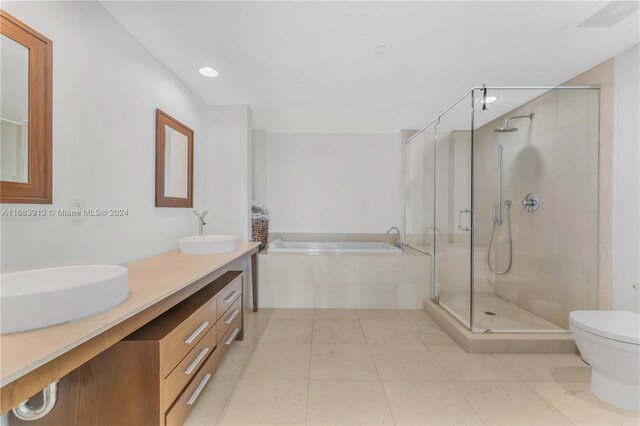 full bathroom featuring vanity, plus walk in shower, toilet, and tile patterned flooring