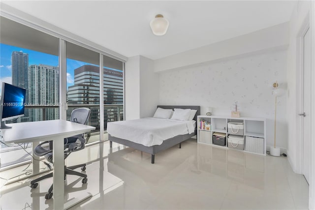 bedroom featuring expansive windows and light tile patterned flooring