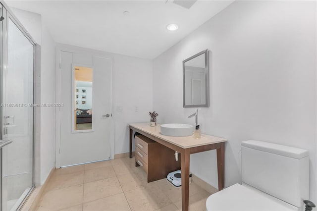 bathroom featuring vanity, toilet, tile patterned floors, and an enclosed shower